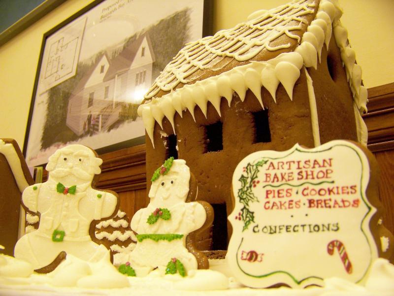 A gingerbread couple greets visitors in front of this creation, courtesy of the Artisan Bake Shop. BY MATTHEW BERNAT